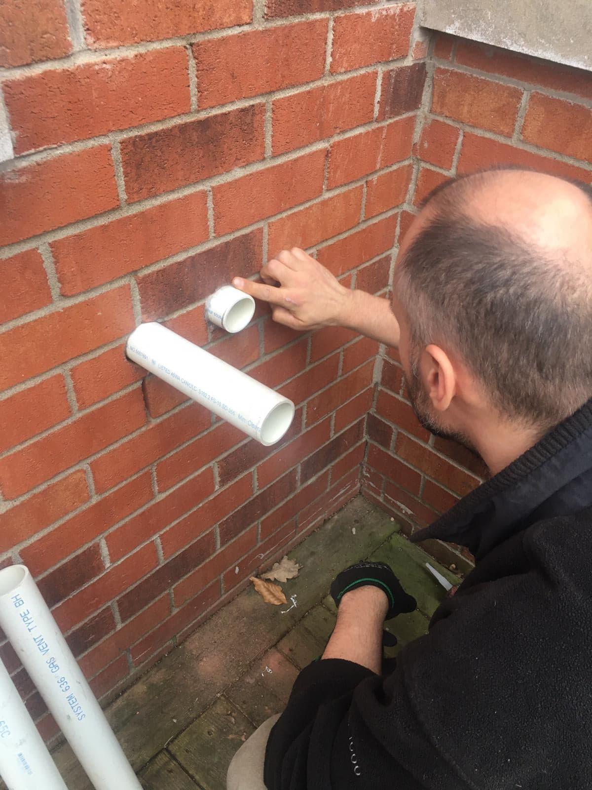 Technician installing pipes